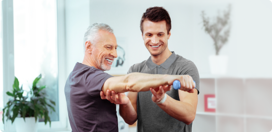 Doctor helping patient with arm exercise